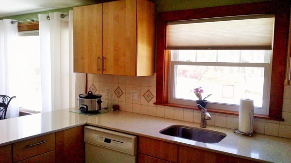 106 Mishawum Road Woburn, MA 01801 - Photo 11 of 23 a kitchen with a sink a counter and cabinets