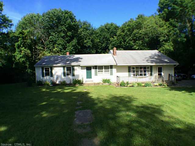65 Cornell Road Plainfield, CT 06374 - Photo 1 of 1 a front view of a house with a garden