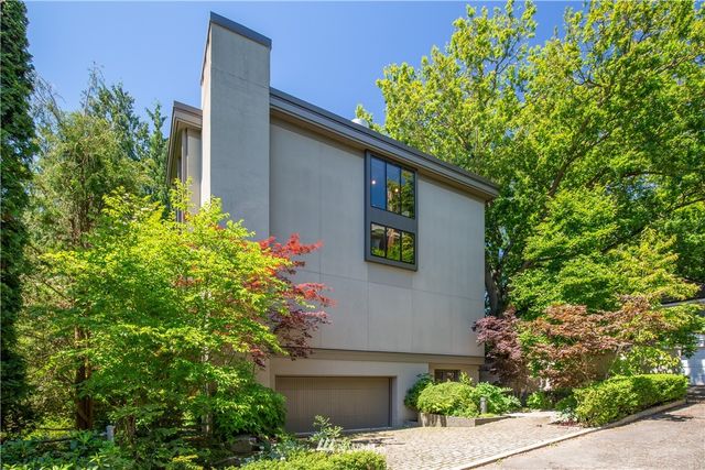 front view of a house with a tree
