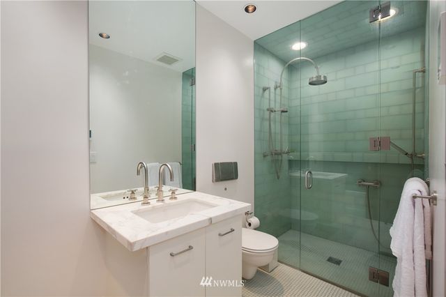 a bathroom with a sink toilet and shower