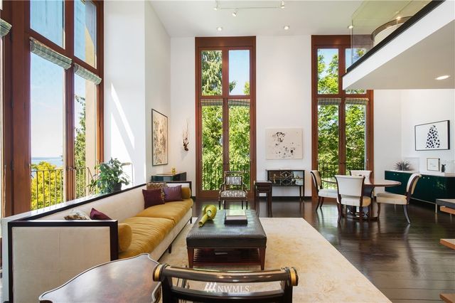 a living room with furniture and floor to ceiling windows