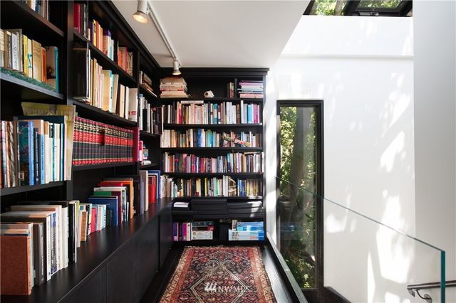 a view of living room with furniture and book shelf