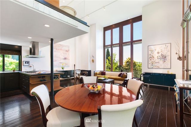 a dining room with furniture a couch and wooden floor