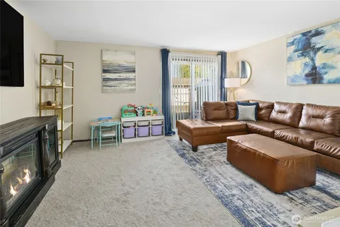 a bedroom with a bed a flat screen tv and dresser