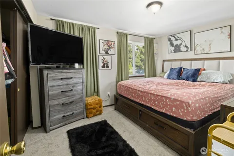 a bedroom with a bed and a flat screen tv