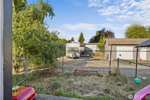 a view of a patio with a table and chairs and potted plants