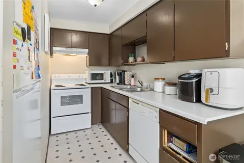 a kitchen with stainless steel appliances a stove a sink and a refrigerator