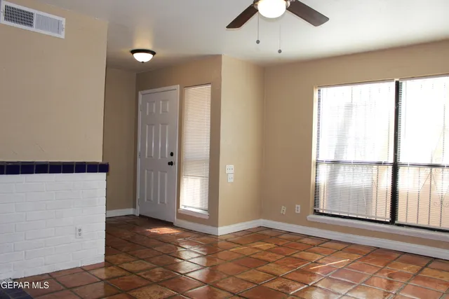 a kitchen with granite countertop white cabinets and black appliances