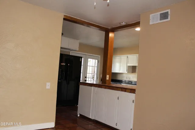 a kitchen with a refrigerator and a stove top oven