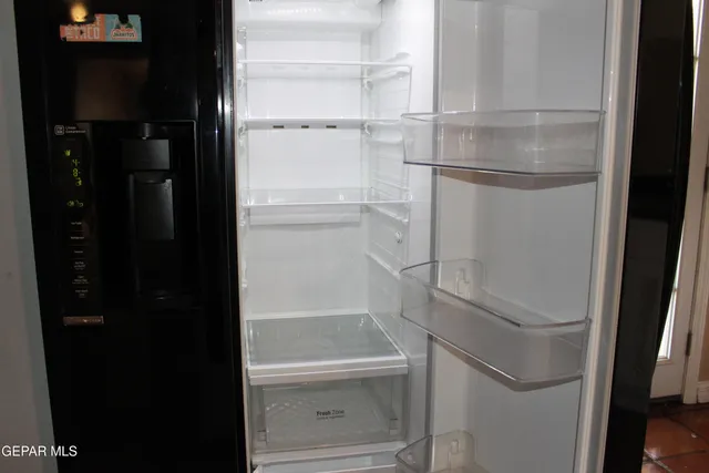 a white toilet sitting next to a white wall