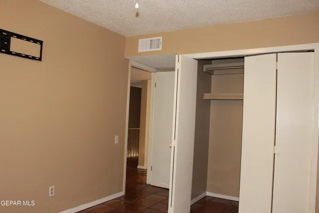 a view of staircase with railing and white walls