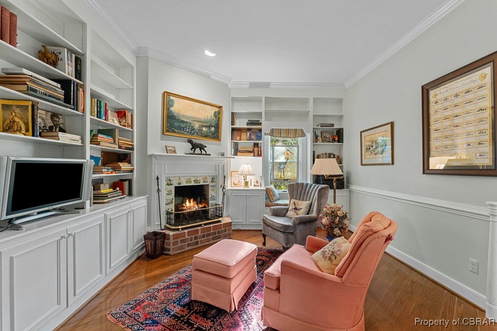184 York Road Irvington, VA 22480 - Photo 28 of 46 Sitting room featuring a fireplace, crown molding, hardwood / wood-style floors, and built in features