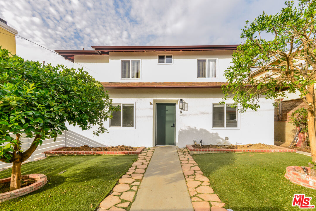 2107 Pullman Lane, Unit A Redondo Beach, CA 90278 - Photo 1 of 42 a front view of a house with garden