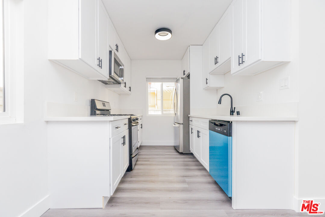2107 Pullman Lane, Unit A Redondo Beach, CA 90278 - Photo 12 of 42 a kitchen with stainless steel appliances a sink and a refrigerator