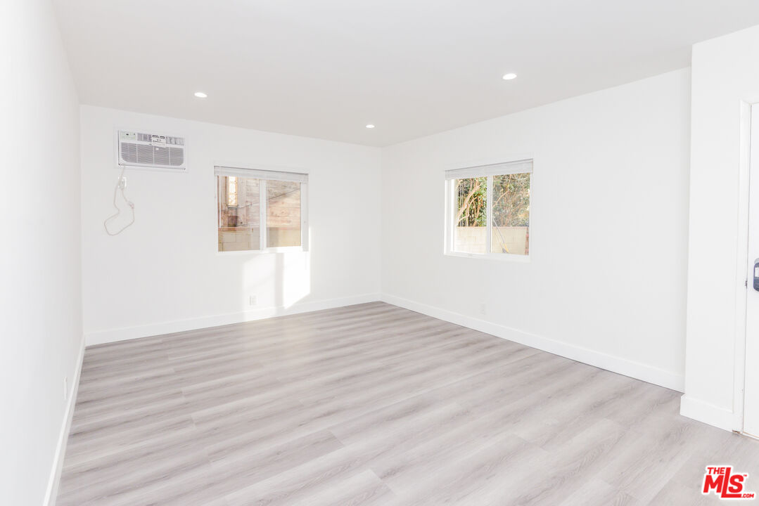 2107 Pullman Lane, Unit A Redondo Beach, CA 90278 - Photo 15 of 42 a view of an empty room with wooden floor and a window