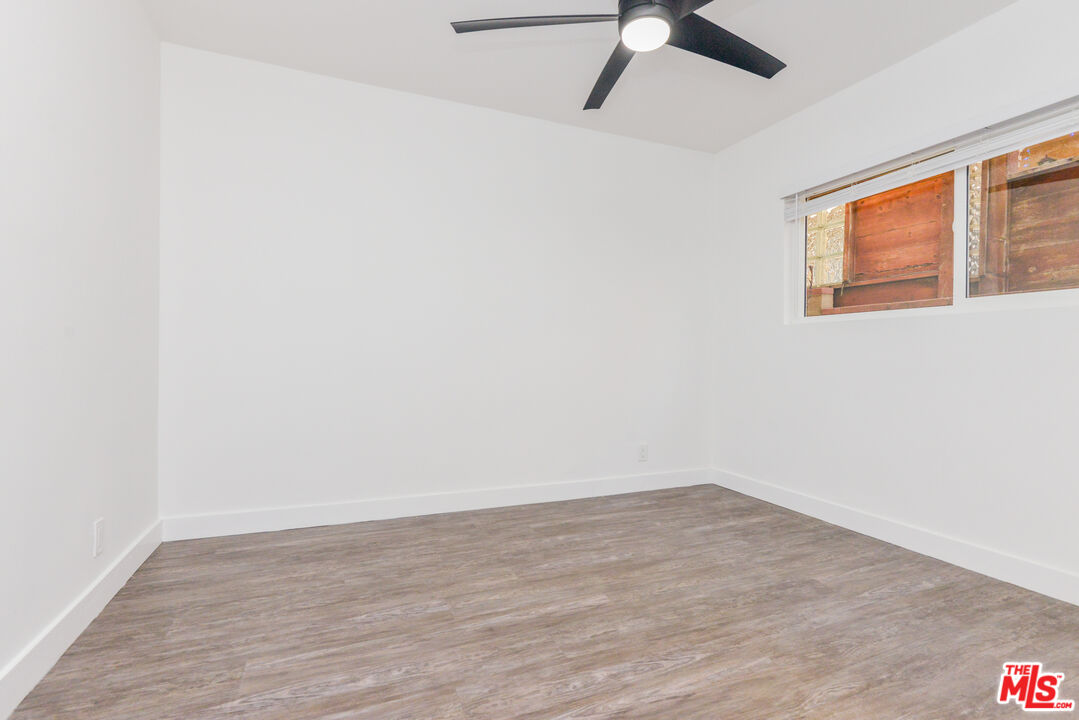 2107 Pullman Lane, Unit A Redondo Beach, CA 90278 - Photo 18 of 42 a view of a room with wooden floor and a ceiling fan