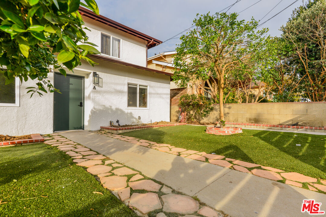 2107 Pullman Lane, Unit A Redondo Beach, CA 90278 - Photo 2 of 42 a front view of a house with a yard and garage