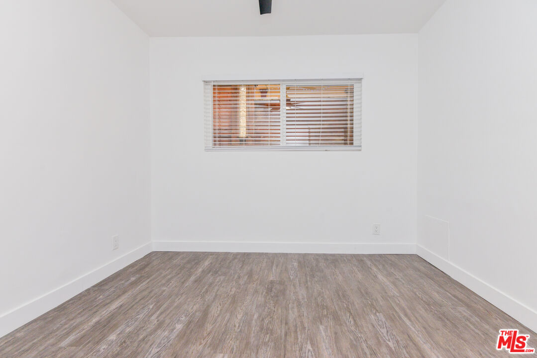 2107 Pullman Lane, Unit A Redondo Beach, CA 90278 - Photo 23 of 42 a view of a room that has wooden floor and a window