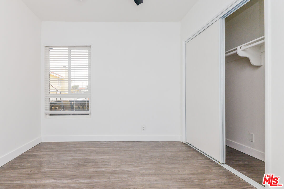 2107 Pullman Lane, Unit A Redondo Beach, CA 90278 - Photo 24 of 42 a view of an empty room with wooden floor and a window