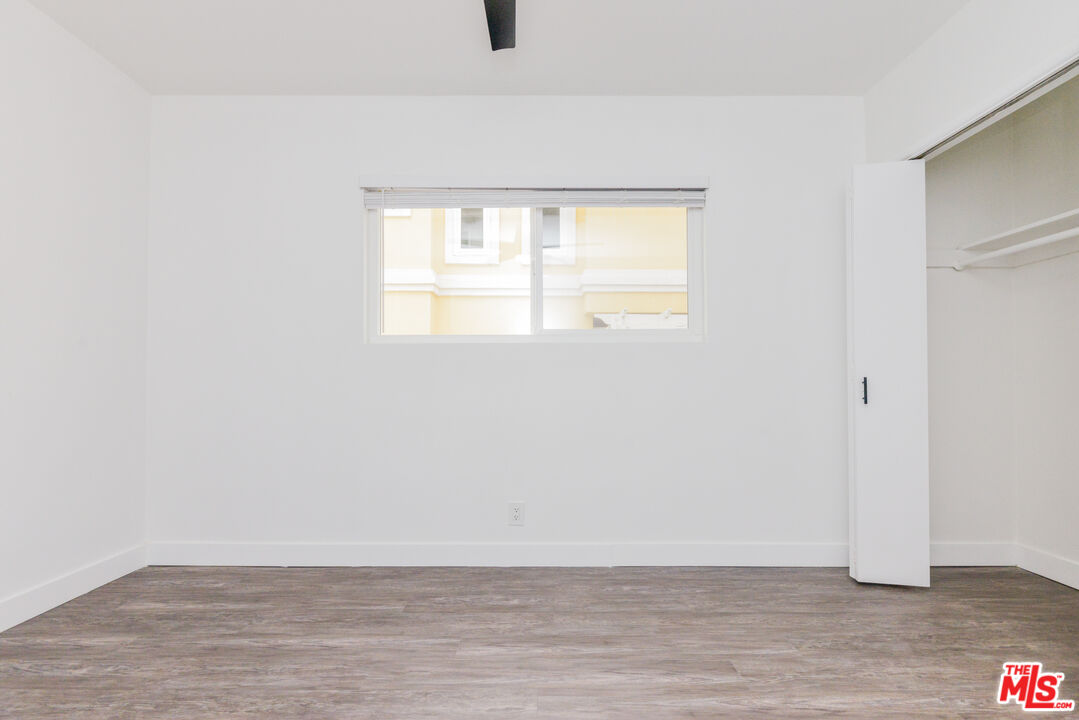 2107 Pullman Lane, Unit A Redondo Beach, CA 90278 - Photo 30 of 42 a view of an empty room with wooden floor and a window