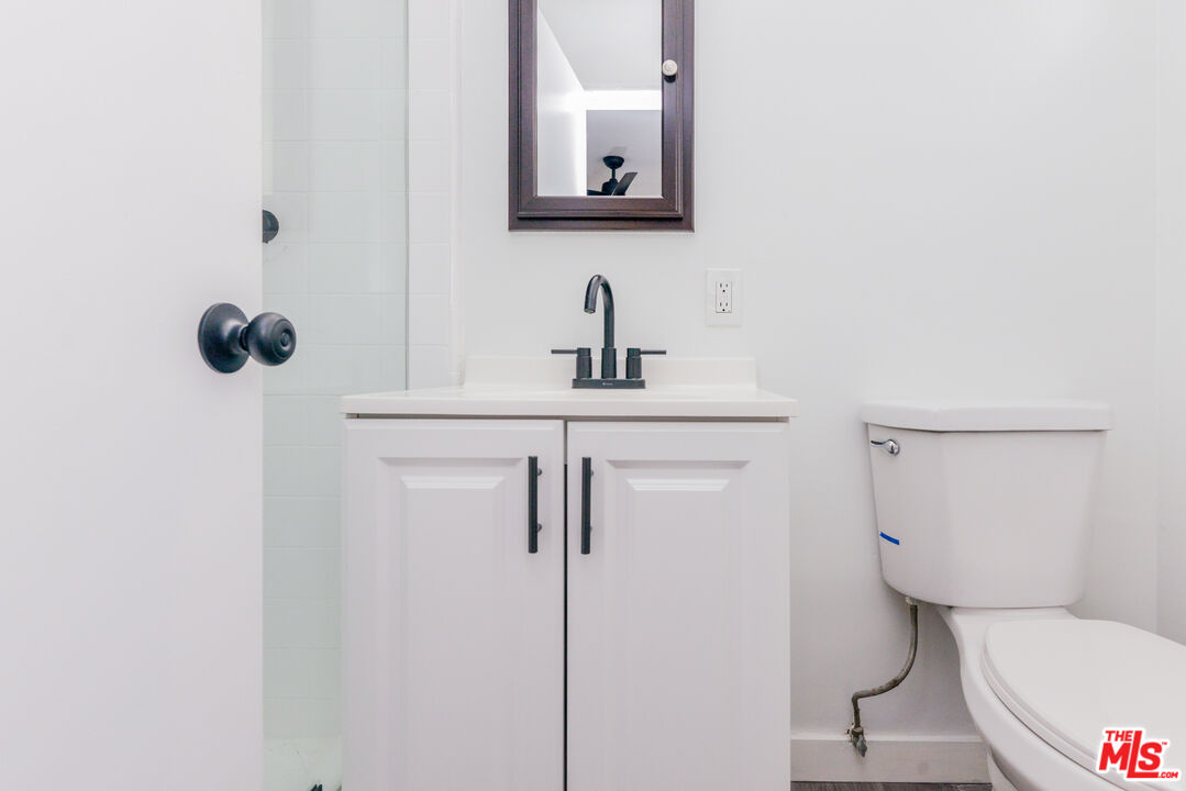 2107 Pullman Lane, Unit A Redondo Beach, CA 90278 - Photo 32 of 42 a bathroom with a toilet sink and mirror
