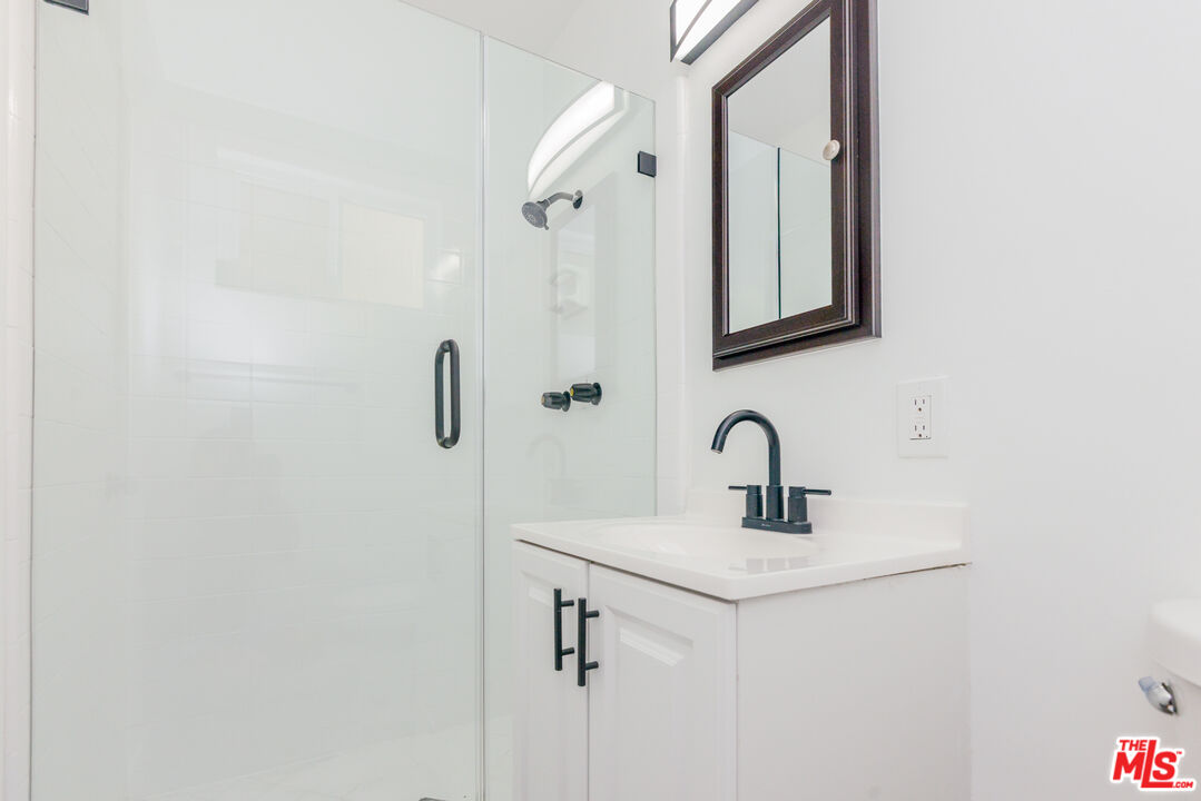 2107 Pullman Lane, Unit A Redondo Beach, CA 90278 - Photo 34 of 42 a bathroom with a sink and a mirror