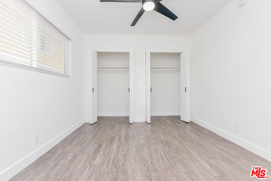 2107 Pullman Lane, Unit A Redondo Beach, CA 90278 - Photo 36 of 42 an empty room with wooden floor cabinet and windows