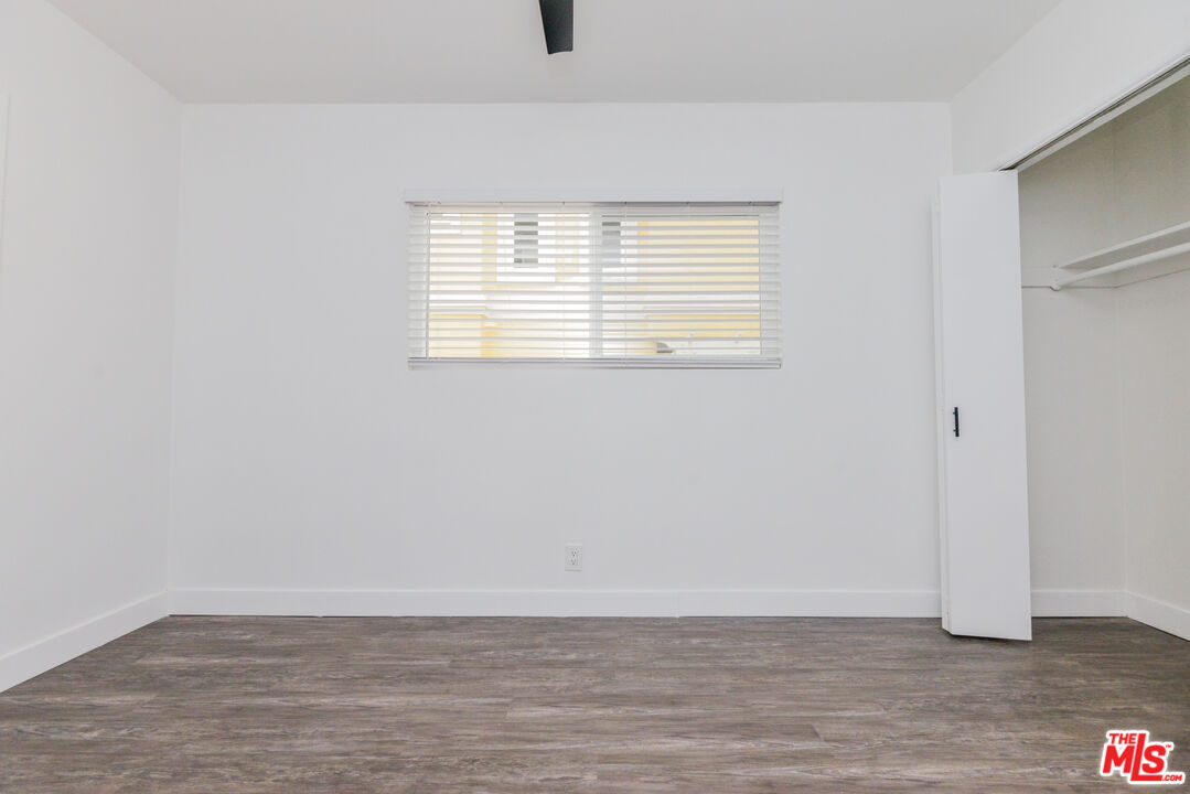 2107 Pullman Lane, Unit A Redondo Beach, CA 90278 - Photo 38 of 42 a view of an empty room with wooden floor and a window