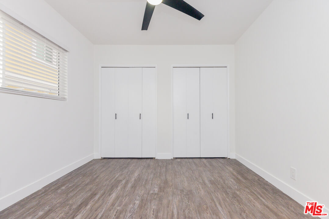 2107 Pullman Lane, Unit A Redondo Beach, CA 90278 - Photo 41 of 42 an empty room with a hardwood and ceiling fan