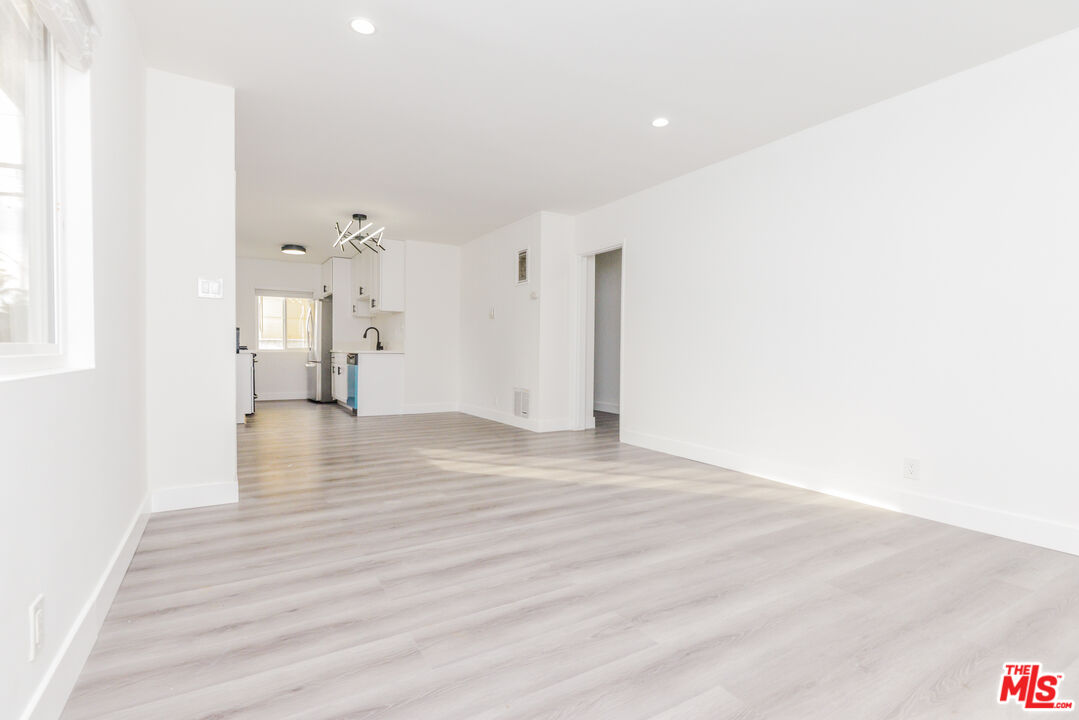 2107 Pullman Lane, Unit A Redondo Beach, CA 90278 - Photo 8 of 42 a view of an empty room with wooden floor and a window