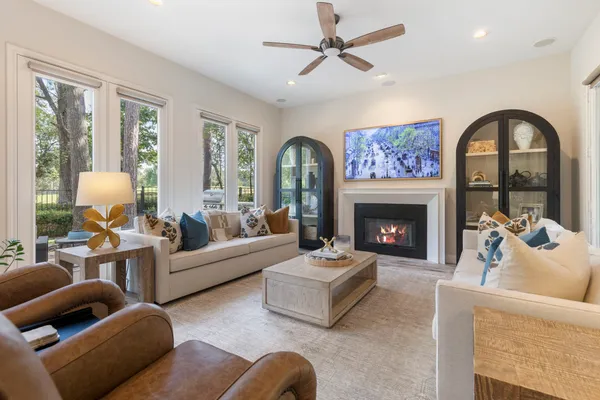 a living room with furniture a fireplace and a large window