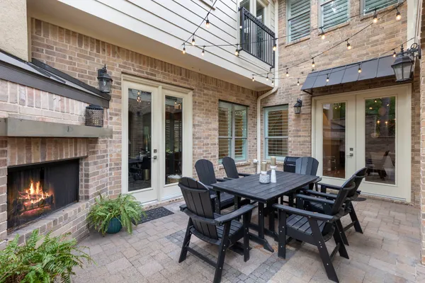 a view of a patio with a table and chairs