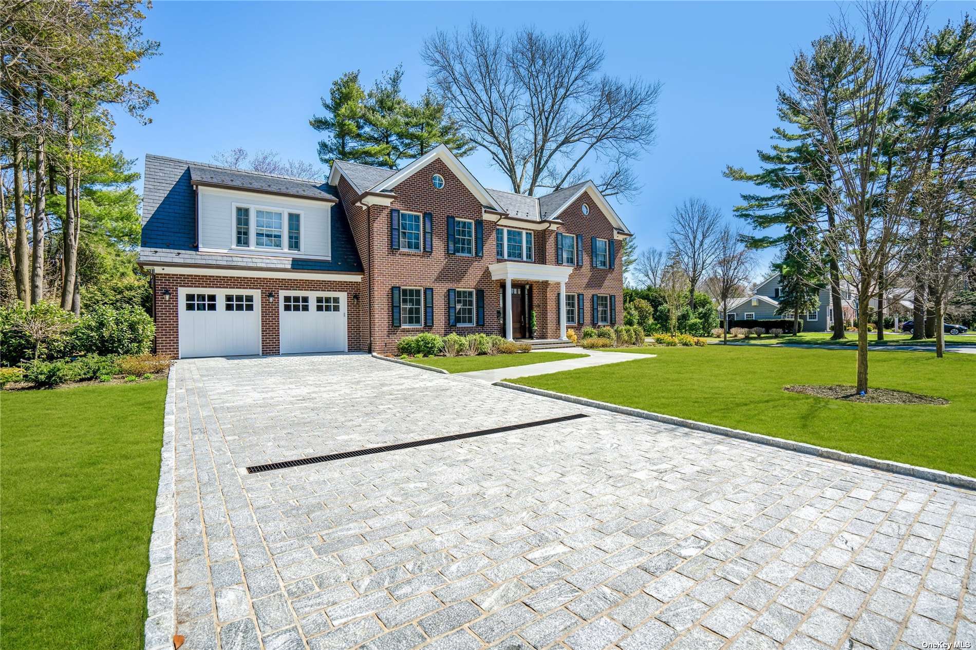 379 Abbey Road Manhasset, NY 11030 - Photo 1 of 1 a view of a white house with a yard and plants