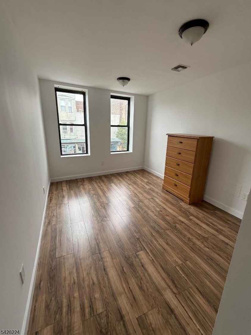 182 Ferry Street, Unit 2F Newark, NJ 07105 - Photo 11 of 14 a view of room with window and wooden floor