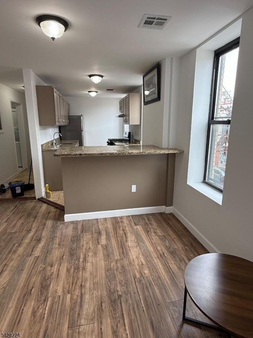 182 Ferry Street, Unit 2F Newark, NJ 07105 - Photo 3 of 14 a view of kitchen and hall with wooden floor