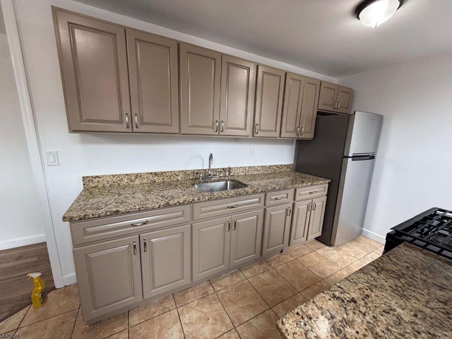 182 Ferry Street, Unit 2F Newark, NJ 07105 - Photo 4 of 14 a kitchen with stainless steel appliances granite countertop a stove a sink and a refrigerator