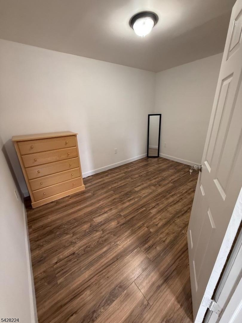 182 Ferry Street, Unit 2F Newark, NJ 07105 - Photo 7 of 14 a view of an empty room and wooden floor