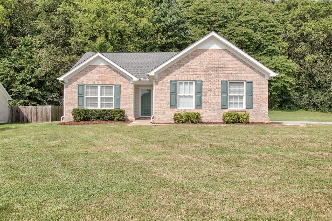 1879 Portway Road Spring Hill, TN 37174 - Photo 1 of 17 a front view of a house with garden