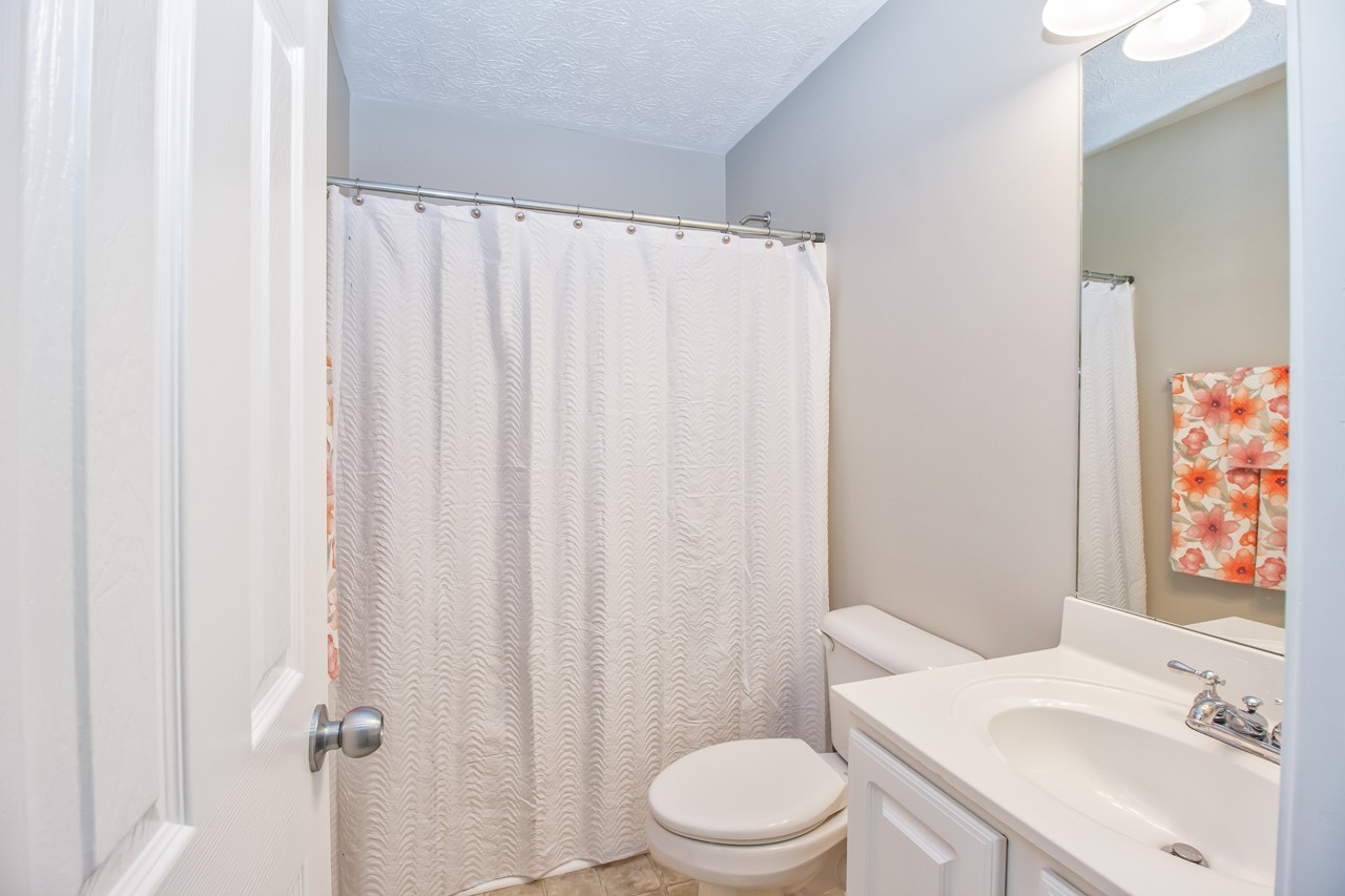 1879 Portway Road Spring Hill, TN 37174 - Photo 12 of 17 a white toilet sitting next to a bathroom sink