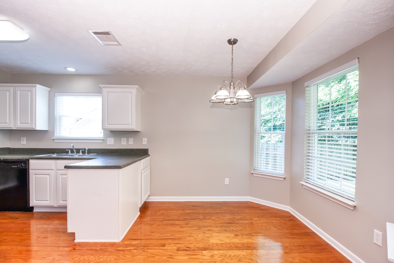 1879 Portway Road Spring Hill, TN 37174 - Photo 14 of 17 a view of a kitchen with granite countertop stainless steel appliances a stove and a wooden floor