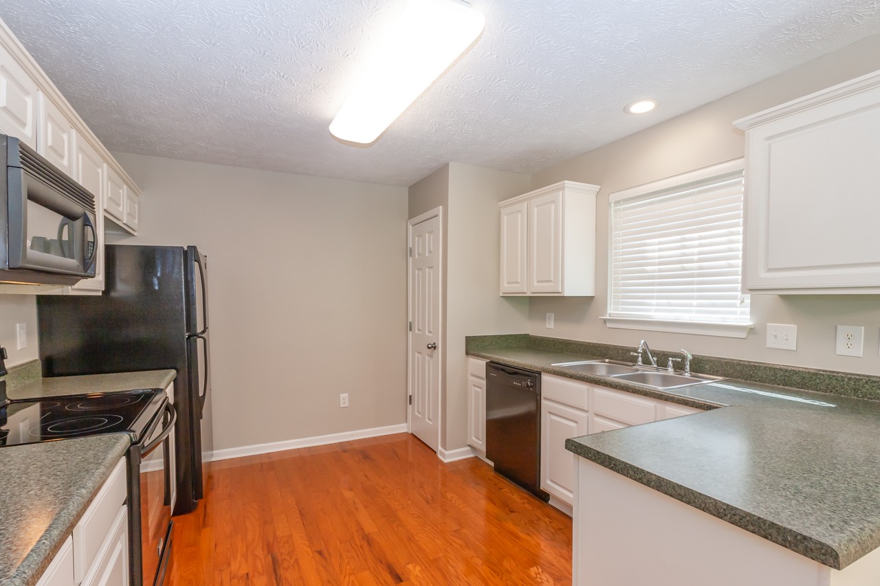 1879 Portway Road Spring Hill, TN 37174 - Photo 15 of 17 a kitchen with stainless steel appliances granite countertop a sink stove and refrigerator