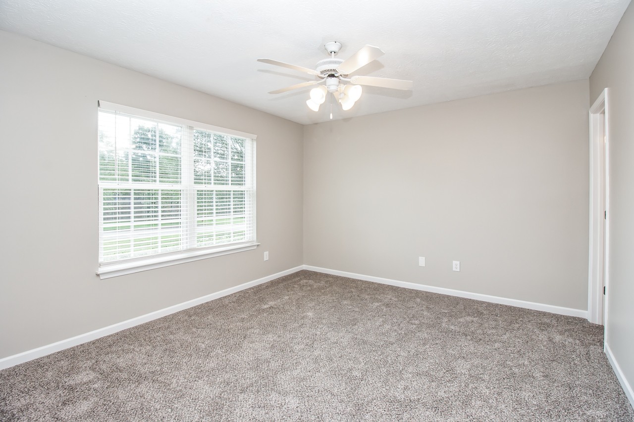 1879 Portway Road Spring Hill, TN 37174 - Photo 5 of 17 an empty room with windows and chandelier fan