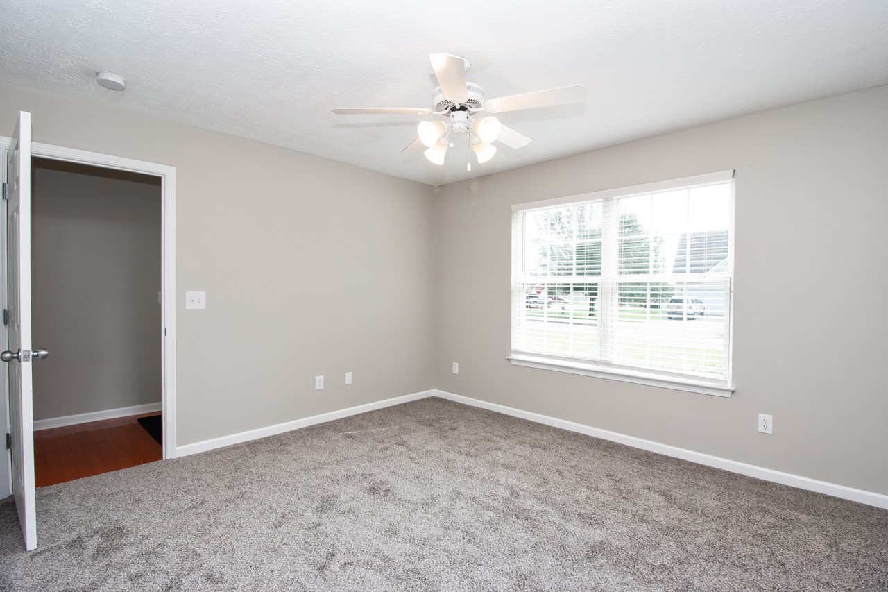 1879 Portway Road Spring Hill, TN 37174 - Photo 6 of 17 an empty room with windows and chandelier fan