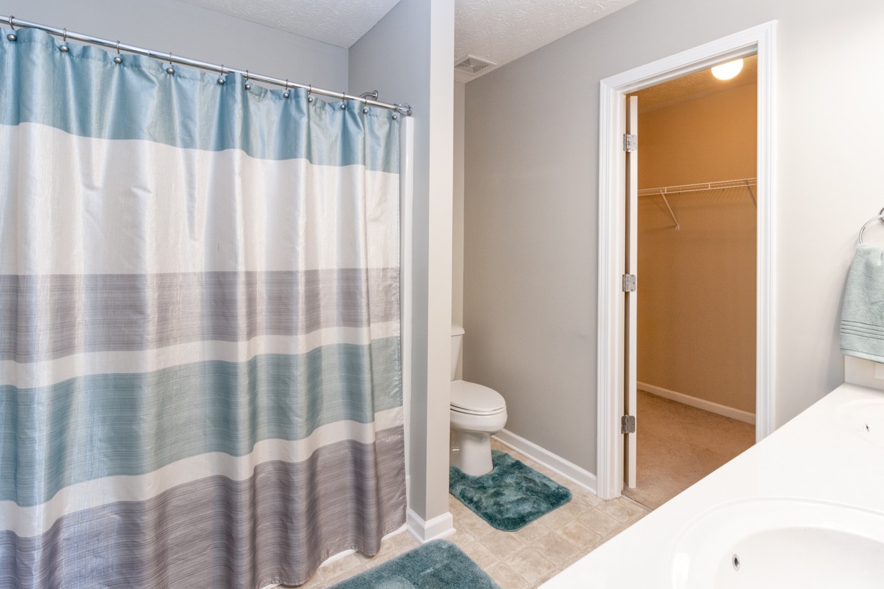 1879 Portway Road Spring Hill, TN 37174 - Photo 7 of 17 a bathroom with a toilet and a shower curtain