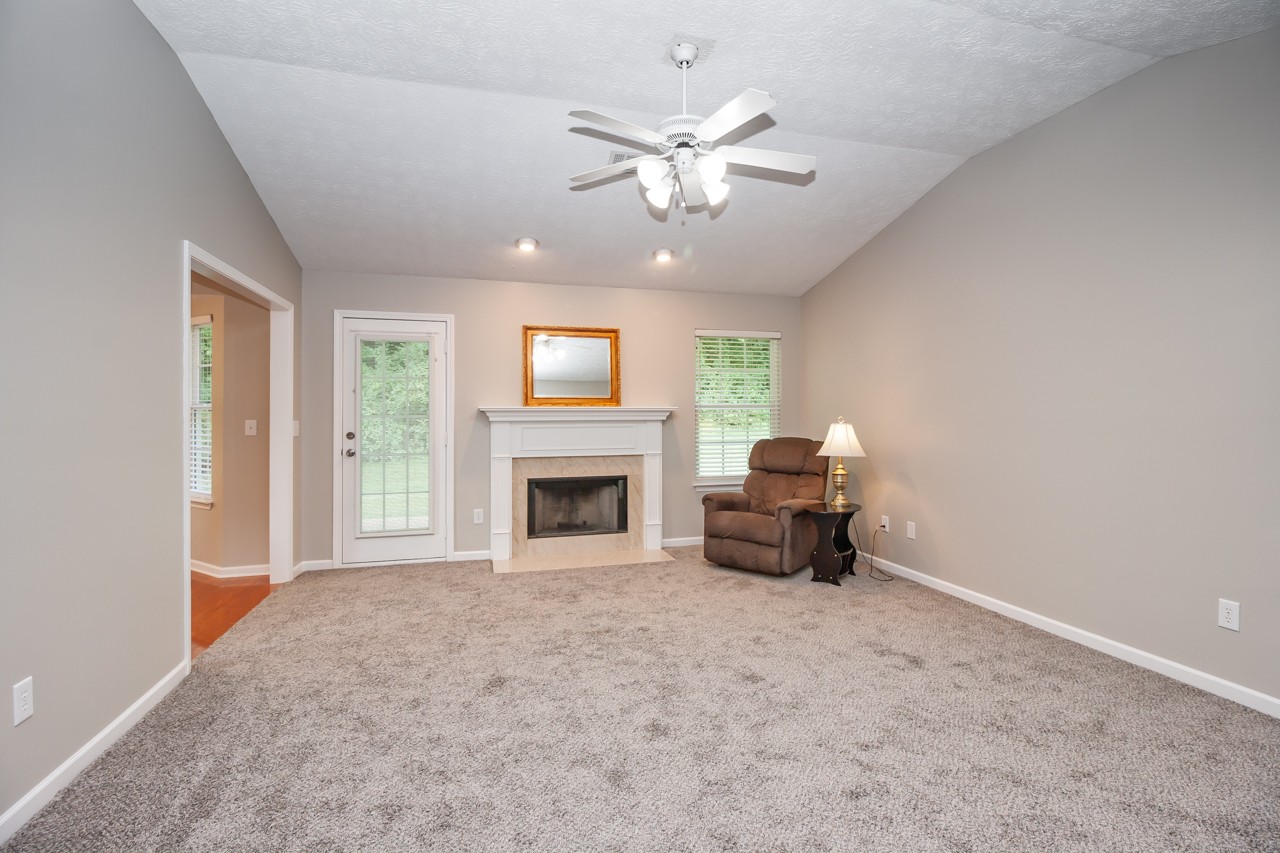 1879 Portway Road Spring Hill, TN 37174 - Photo 10 of 17 a living room with furniture and a fireplace