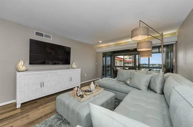 a kitchen with stainless steel appliances granite countertop a stove top oven a sink dishwasher and a microwave oven with large cabinets