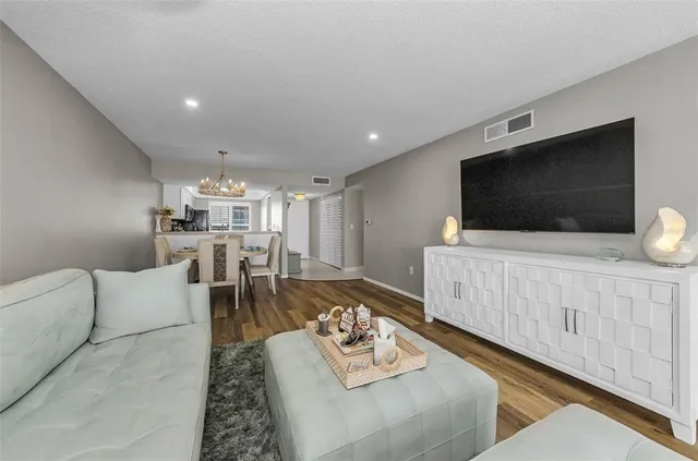 a kitchen with stainless steel appliances a stove microwave and a sink
