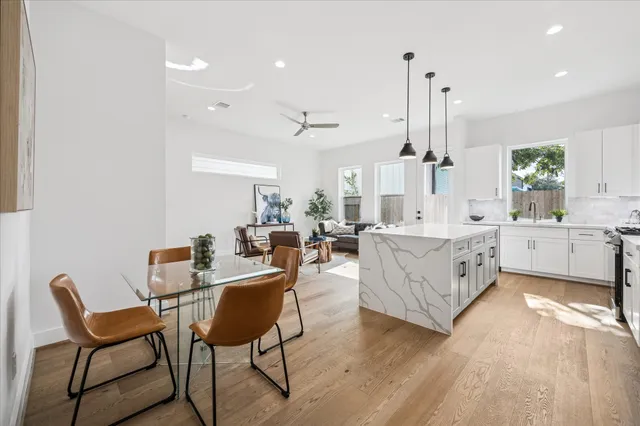 a large kitchen with a table and chairs