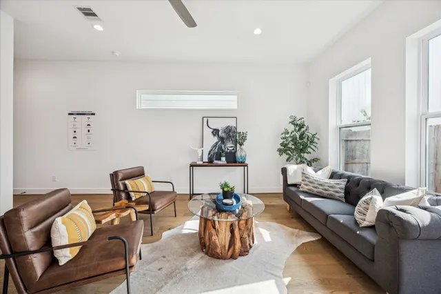 a living room with furniture and a potted plant