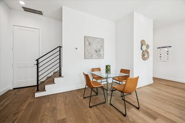 a view of a room with wooden floor and a hallway